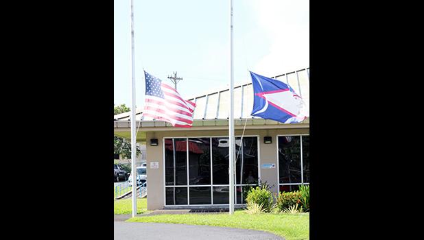 American Samoa and U.S. flags at half staff