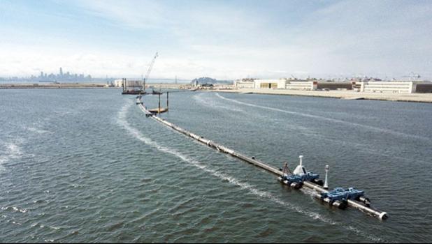 n this Monday, Aug. 27, 2018 photo provided by The Ocean Cleanup, a long floating boom that will be used to corral plastic litter in the Pacific Ocean is assembled in Alameda, Calif. Engineers will deploy a trash collection device to corral plastic litter floating between California and Hawaii in an attempt to clean up the world’s largest garbage patch. The 2,000-foot (600-meter) long floating boom will be towed Saturday, Sept. 8, 2018, from San Francisco to the Great Pacific Garbage Patch, an island of trash twice the size of Texas. (The Ocean Cleanup via AP) Floating boom that will be used to corral plastic litter