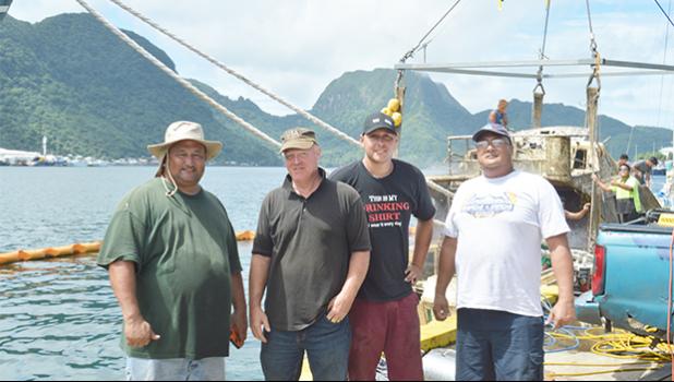 The two local businessmen who worked together to pull up the sunken Fo’isia vessel yesterday at the Malaloa Marina: (l-r) Iupeli Kava and Timothy Jones Sr., together with Timothy Jones Jr., and a bystander. The government owned Fo'isia sank - for reasons unknown - earlier this year in May. [photo: AF]