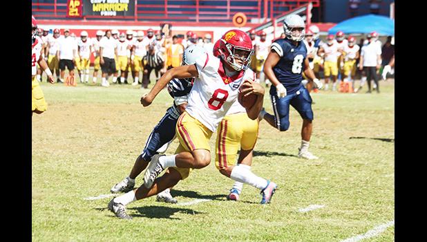Tafuna Warriors quarterback Oakland Salave’a scrambling through midfield 