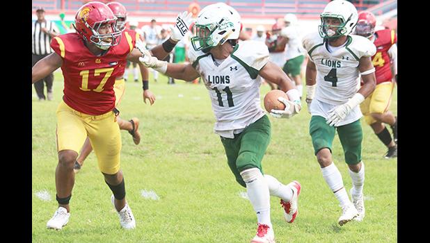 Pearson Livi of the Leone Lions focus on timing his stiff arm 
