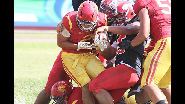 Faga’itua defenders trying to strip the ball out of Koison Ozu’s grip