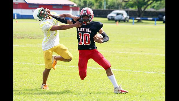 Faga’itua Viking’s Scott Pese (10) puts a stiff arm to the face of a Leone defender
