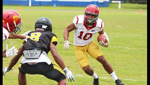 Tafuna Warriors’ John Allen (10) tries to evade a Nu’uuli Wildcat