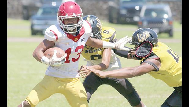 Tafuna’s ball carrier trying to evade the pressure from two Nu’uuli Wildcat defenders