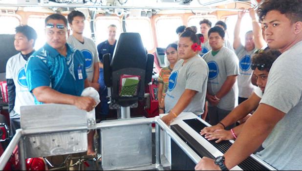 USCG official Frank Thomsen with a group of local teens who toured the USCG Cutter Joseph Gerczak