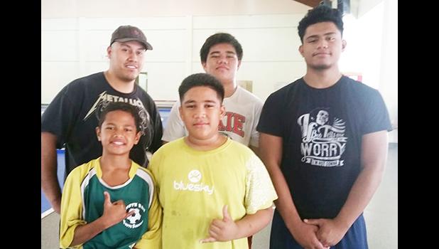 Aspiring wrestlers from around the territory were at the DYWA Pago Pago Community Youth Center yesterday morning to take advantage of the free wrestling clinics being conducted by Alex Ramirez (back row far left), an educator and high school wrestling coach from southern California.  [photo: Blue Chen-Fruean]