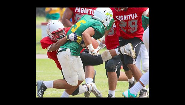 Faga'itua Vikings Leroy Fesili immediately engaging Leone's Luteru Ah Loe in the backfield for a loss in the first half of their varsity game this past Saturday. Fesili leads the Vikings on both offense and defense – unfortunately they came up short in their 22-6 loss against the Lions. [photo: TG]