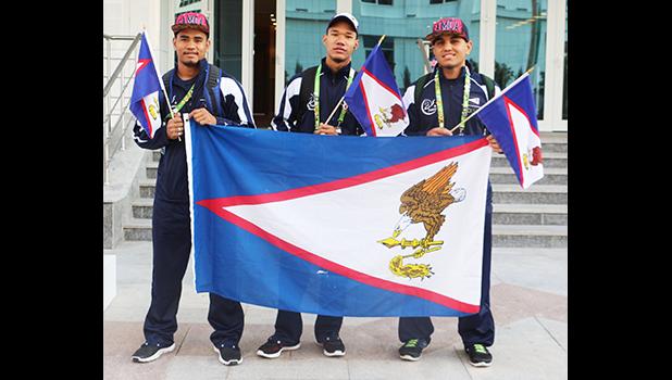 Team AS Wrestlers, Iafeta Vou, Danieal Misaalefua, Nolan Puletasi with the American Samoa Flag on their way over to the wrestling arena for the first matches of the day. Puletasi and Misaalefua were able to advance to wrestle for the bronze medal in their respective categories but both lost in the end. (Photo: Terry Custodio Auva'a)