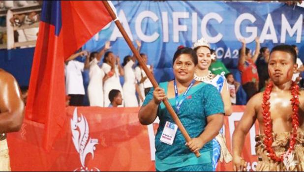 Samoan weightlifter Feagaiga Stowers carrying Samoa flag