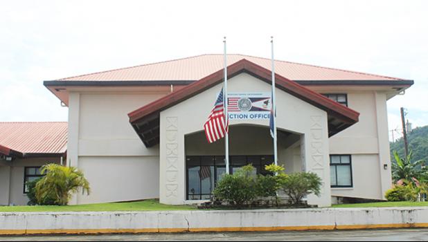 Flags at half staff in front of election office
