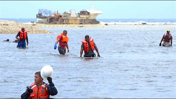USCG personnel and grounded vessel