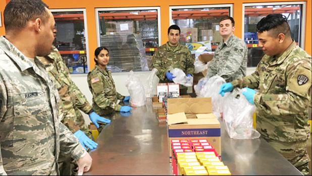 New York Army and Air National Guardsmen pack food parcels at Feeding Westchester, a food pantry in Westchester County, N.Y.
