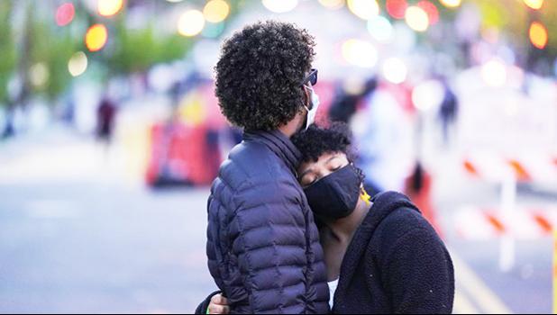 A couple dances at Black Lives Matter Plaza near the White House on Tuesday, April 20, 2021, in Washington, after the verdict in Minneapolis, in the murder trial against former Minneapolis police officer Derek Chauvin was announced. (AP Photo/Alex Brandon) A couple dances at Black Lives Matter Plaza near the White House
