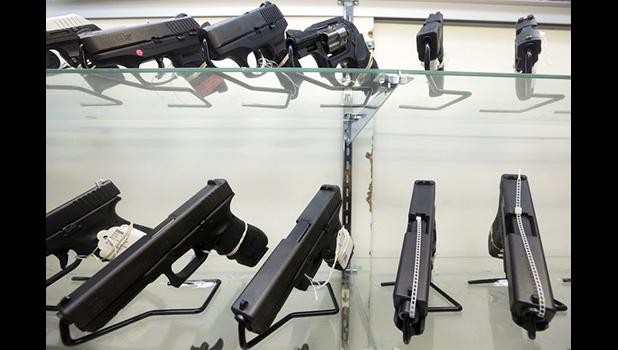This June 29, 2016, file photo shows guns on display at a gun store in Miami. Support for tougher gun control laws is soaring in the United States, according to a new poll that found a majority of gun owners and half of Republicans favor new laws to address gun violence in the weeks after a Florida school shooting left 17 dead and sparked nationwide protests. (AP Photo/Alan Diaz, File) This June 29, 2016, file photo shows guns on display at a gun store in Miami. Support for tougher gun control laws is soaring in the United States, according to a new poll that found a majority of gun owners and half of Republicans favor new laws to address gun violence in the weeks after a Florida school shooting left 17 dead and sparked nationwide protests. (AP Photo/Alan Diaz, File)
