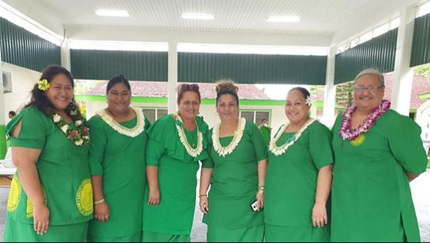 Teachers and principal pictured inside new gym