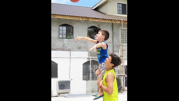 Micah Corry bolsters his younger brother, Riley, to make a first shot.  [Courtesy photo]