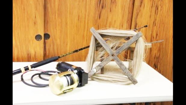 hand cranked reel beside an electric reel