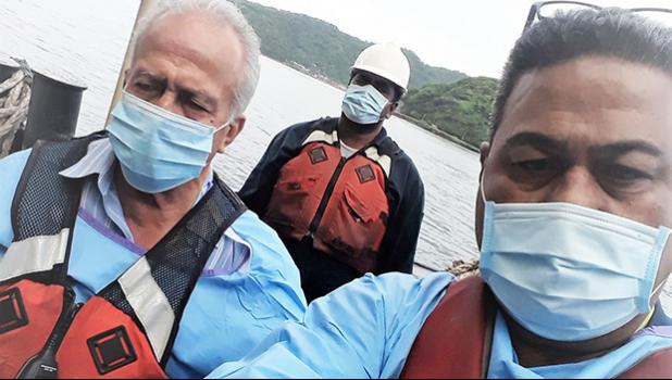 Harbor Master Silila Patane (left), Health official John Fuimaono (right) unnamed man in background