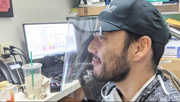 Dr. Eric Muraoka wearing one of his face shields he printed on his 3-D printer