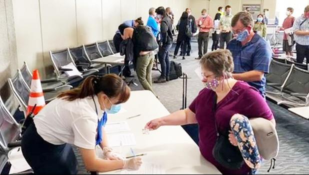 Airport screening (Source: HI Dept. of Transportation) Woman being screened at a Hawaii airport