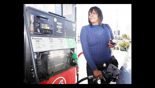 According to the report, the Transportation index is majorly affected by changes in unleaded gas and diesel prices. woman pumping gasoline into her car