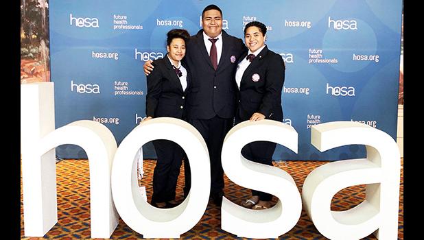  (l-r) students Chole Tuaua and Darius Shimasaki-Vaofanua and ASCC HOSA Coordinator Monica Afalava.