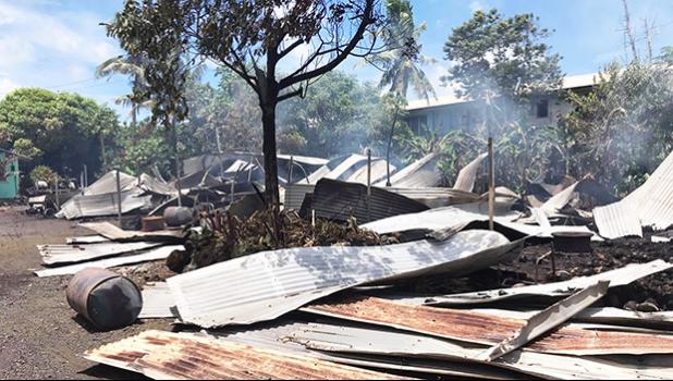 roofing iron smoldering and spread around on the ground