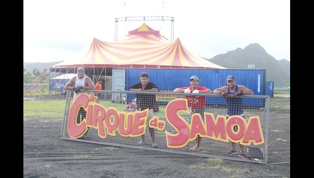 Employees of The Magic Circus of Samoa posing with their sign