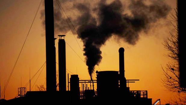 Smoke billows from a chimney of the Solvay factory for production and processing of plastic materials, in Ospiate, near Milan, Italy, Friday, Dec. 14, 2018