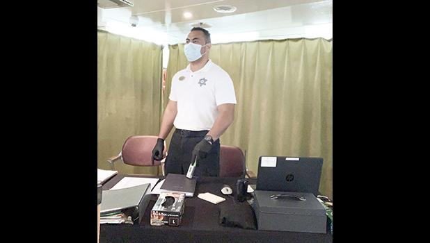 Jake Tagaloa with a mask and gloves protecting himself and others from the virus