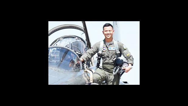 2nd LT Hanyoun Ao Jeong stepping into the cockpit of a jet airplane