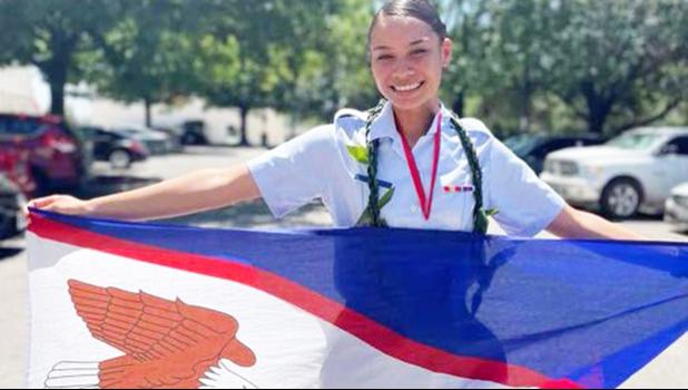 Joanya Tafua holding the American Samoa flag