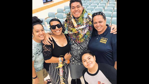June Ifopo on graduation day with family