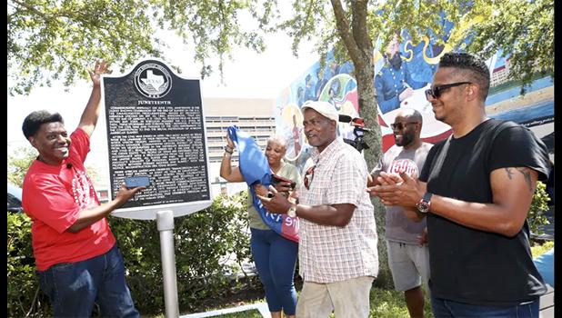 Sam Collins III, left, and others celebrate at the Juneteenth historical marker on June 17, 2021, in Galveston, Texas, after President Joe Biden signed the Juneteenth National Independence Day Act into law. Communities all over the country will be marking Juneteenth, the day that enslaved Black Americans learned they were free. For generations, the end of one of the darkest chapters in U.S. history has been recognized with joy in the form of parades, street festivals, musical performances or cookouts. Yet, the U.S. government was slow to embrace the occasion. (Jennifer Reynolds/ The Galveston County Daily News via AP, File) Juneteenth historic market in Galveston Texas