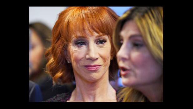 In this June 2, 2017, file photo, comedian Kathy Griffin, left, listens as her attorney Lisa Bloom speaks during a news conference in Los Angeles, to discuss the backlash since Griffin released a photo and video of her displaying a likeness of President Donald Trump's severed head. The AP reported on July 28, 2017, that a story claiming Griffin was jailed last month for walking around New York wearing fake blood and a Trump Halloween mask is a hoax. (AP Photo/Mark J. Terrill, File)