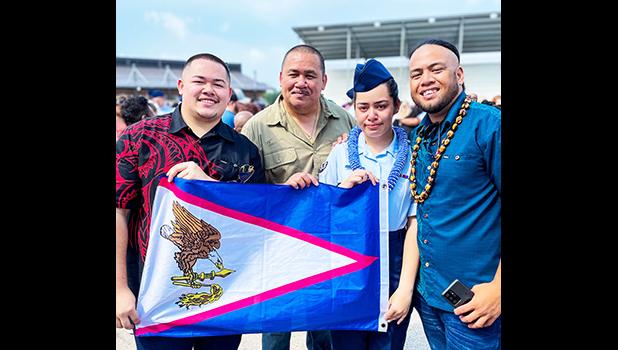 Kathlynn Faaita with family holding an American Samoa flag
