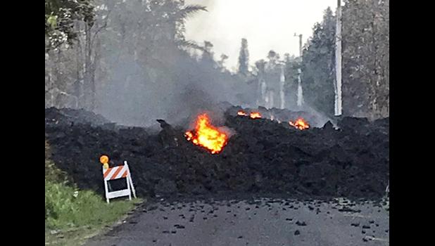 This photo provided by Hawaii Electric Light shows lava flowing over Mohala Street in the Leilani Estates area near Pahoa on the Big Island of Hawaii Friday, May 4, 2018. Nearly 1,500 people have fled from their homes after Hawaii’s Kilauea volcano sent molten lava chewing through forests and bubbling up on paved streets in an eruption that one resident described as “a curtain of fire.” (Hawaii Electric Light via AP) This photo provided by Hawaii Electric Light shows lava flowing over Mohala Street in the Leilani Estates area near Pahoa on the Big Island of Hawaii Friday, May 4, 2018. Nearly 1,500 people have fled from their homes after Hawaii’s Kilauea volcano sent molten lava chewing through forests and bubbling up on paved streets in an eruption that one resident described as “a curtain of fire.” (Hawaii Electric Light via AP)