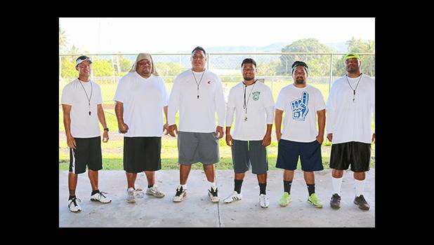 Lions coaching staff led by Head Coach Okland Salave'a (center) posing for a group photo just before practice. Salave’a is the former head coach for the Tafuna High School football program — leading them to a ‘3-peat’ football championship, a THS record. However, last year, the Vikings defeated the Warriors stopping THS’ dreams of a 4-peat record.  [photo: TG]