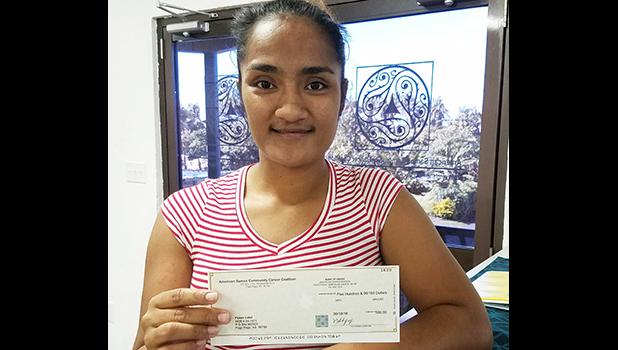 Fuaao Letoi's daughter is pictured receiving Fuaao's 2nd stipend