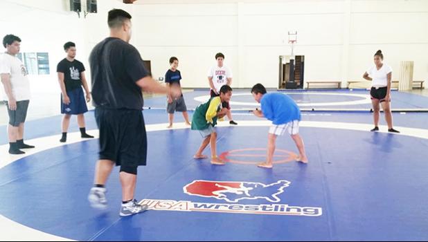 Two of the youngest participants who showed up yesterday for the free wrestling clinics being held at the DYWA Pago Pago Youth Center and taught by visiting coach Alex Ramirez. [photo: Blue Chen-Fruean]