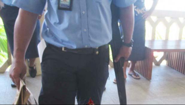Police officers with the gun outside Samoa court