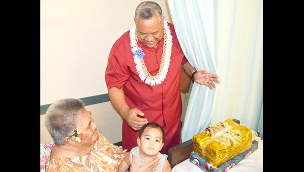 Lt. Governor Lemanu Peleti Mauga after he presented a gift to a woman and her granddaughter, during the Governor’s annual visit at the Pediatric Ward at LBJ Hospital yesterday morning. [photo by AF