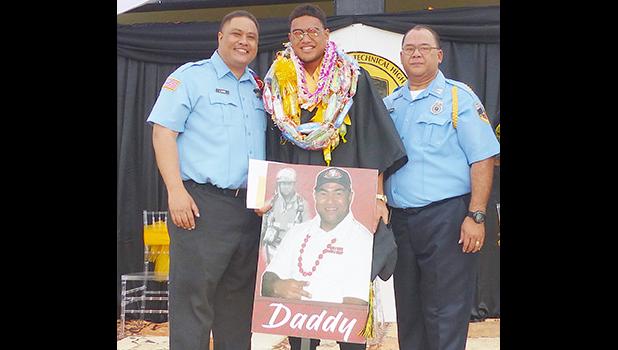 Malachi with portrait of his father and two firefighters