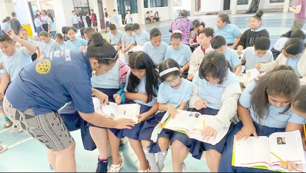 Manumalo Academy 3rd graders look through their new dictionaries
