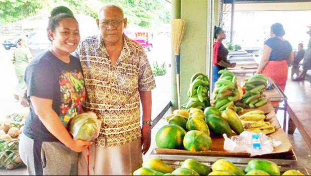 Ti’a Ofisa of Faga'itua with his granddaughter looking through the local produce sold at the Market Place in Fagatogo yesterday afternoon. Under the Reimbursement of Transportation Cost Payment Program (RTCP) commercial farmers in American Samoa are eligible to recoup up to 25% of their transportation costs for farm purchases made in fiscal year 2017. See story for full details.  [photo: Sabrina Amosa]