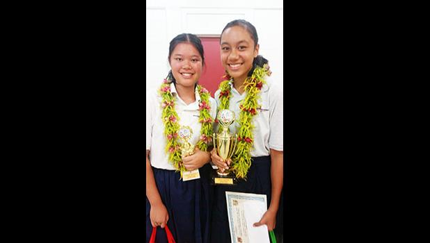 Schoolmates Jennifer Liang and Evelini Suani shined last week during the Territorial Math Competition. Liang placed third in the 8th grade division while Suani came in second place for the 9th grade division. [photo: Blue Chen-Fruean]