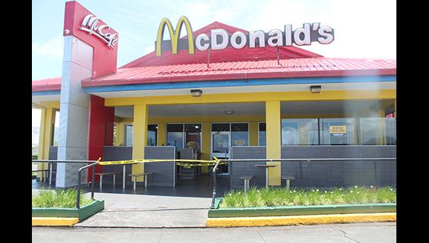 McDonald's with yellow tape around front door.