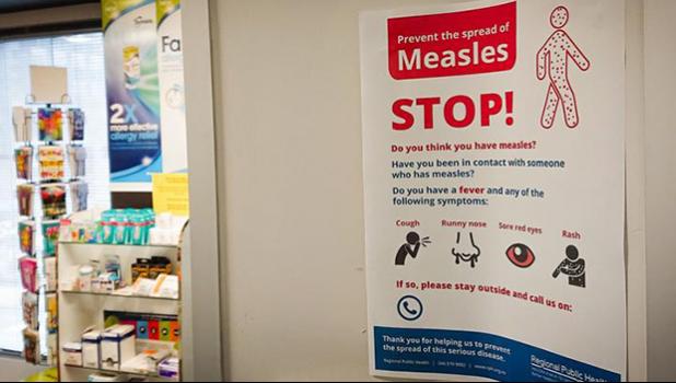 Poster warns against the spread of measles.