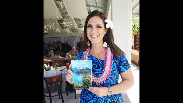 Melinda Laura Clayville holding the guidebook 